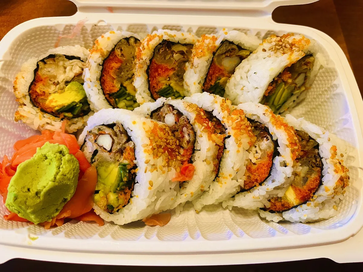 Sushi rolls with avocado, roe, ginger, and wasabi