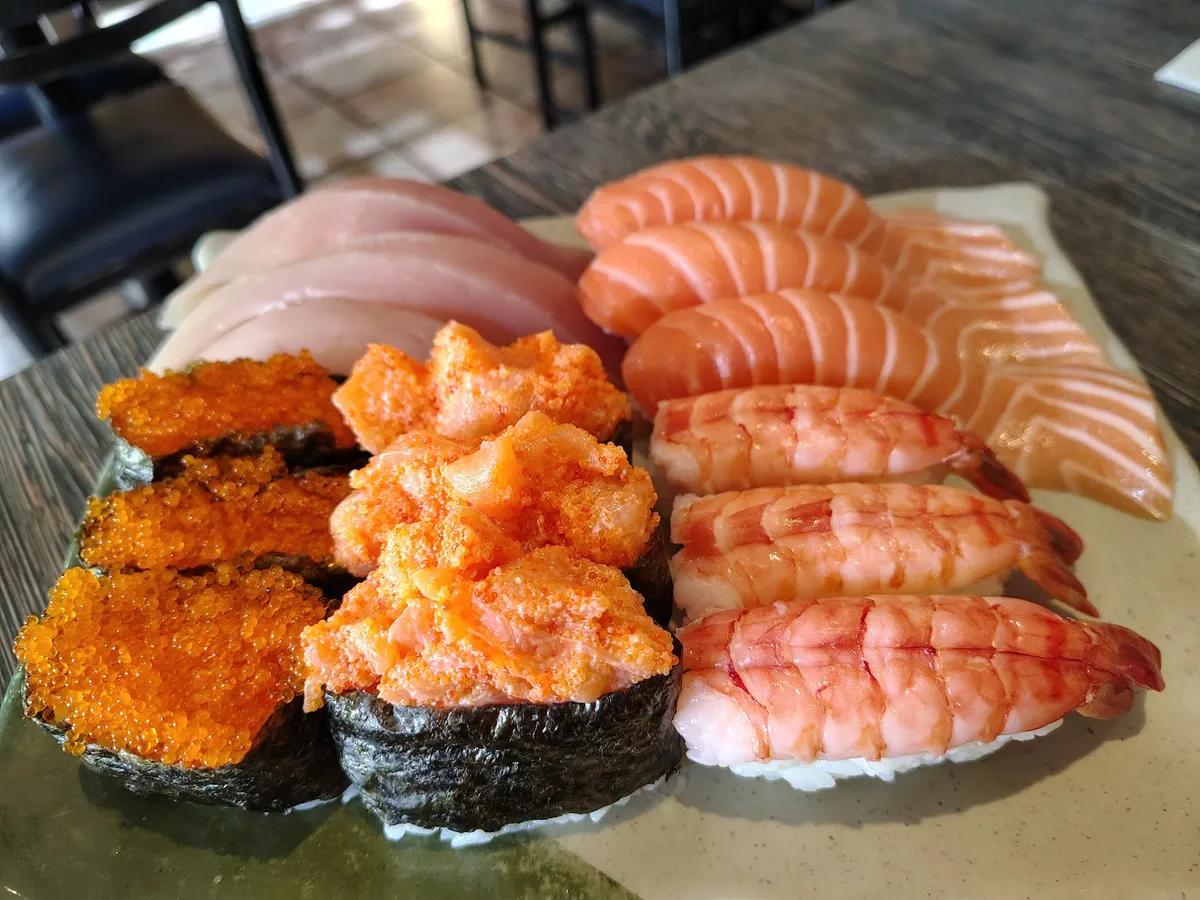Plate of sushi and sashimi with wasabi and ginger